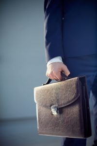 businessman-in-blue-suit-holds-leather-briefcase-2026-09-22-03-40-26-utc